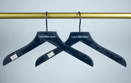 thicker flat bespoken clothes hanger in blue,vendor calvin klein india branch,with white logo printing on hanger,rubber coating, powder spraying blur color hook